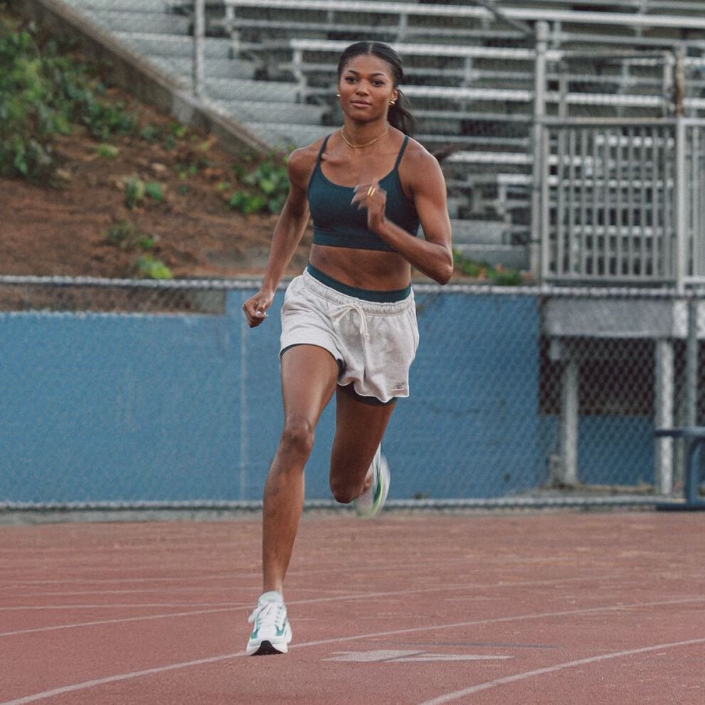 Gabby Thomas running on a track 
